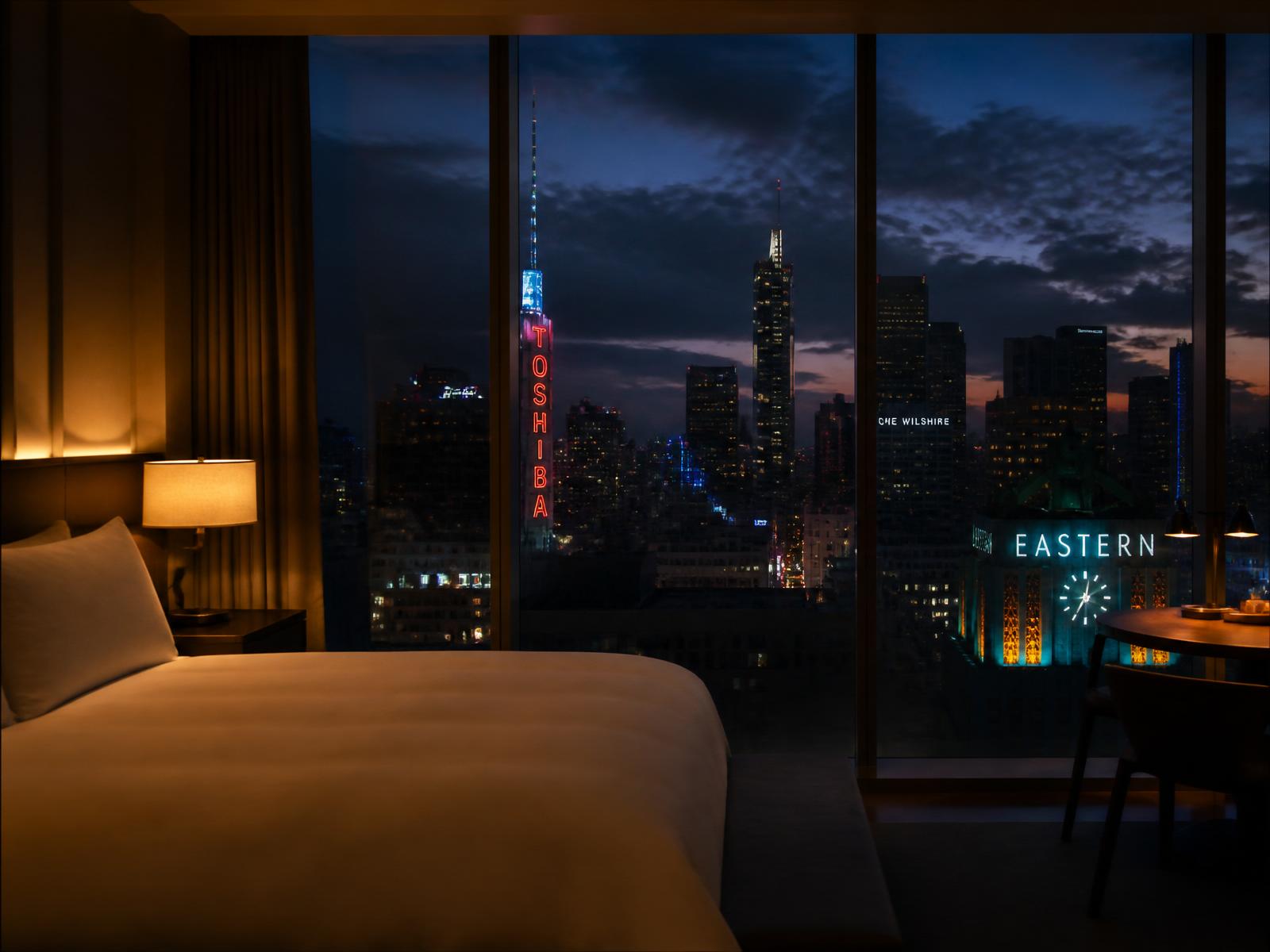Luxury hotel room at night with city skyline